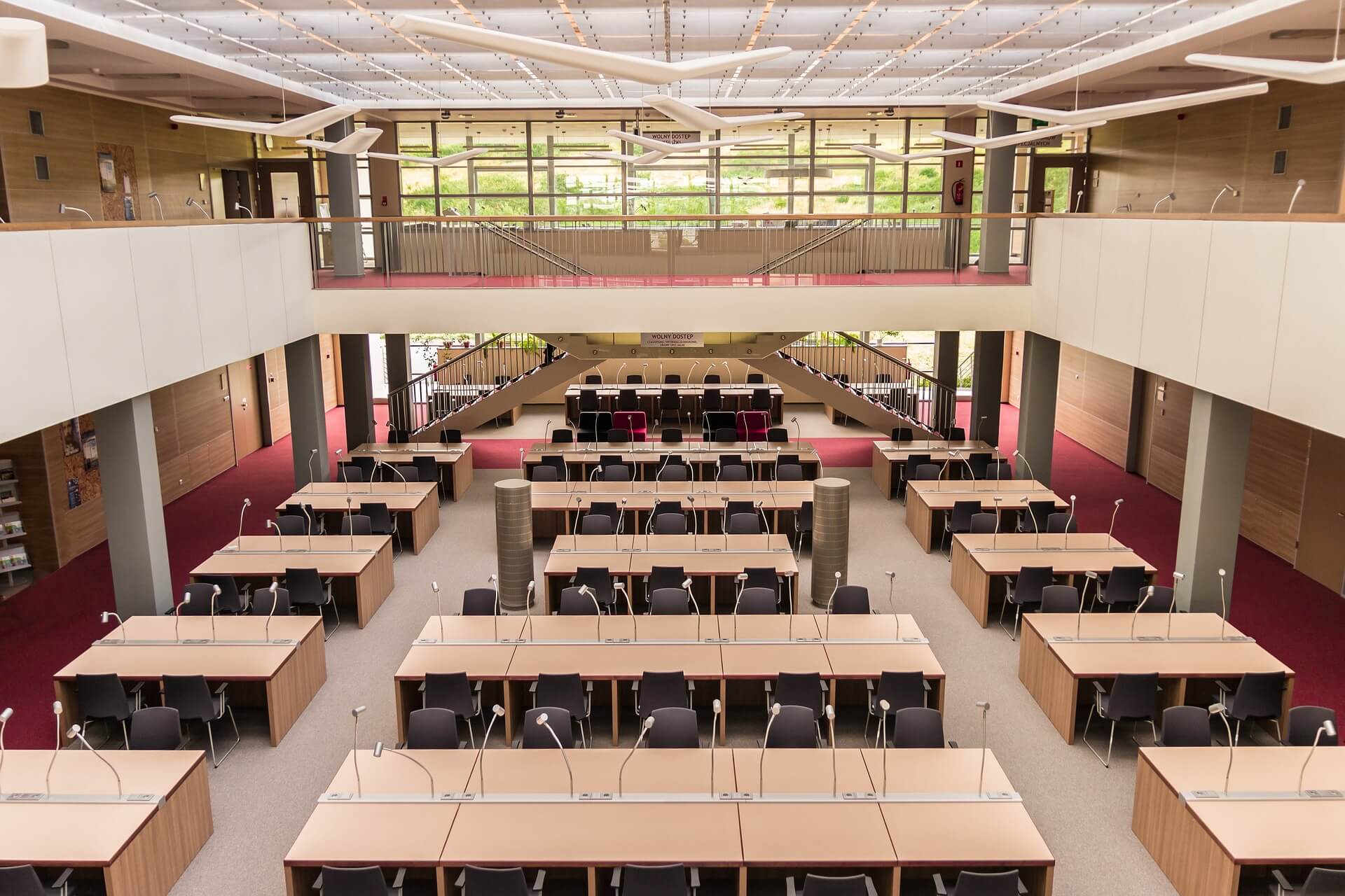 lecture room with tables, chairs and mircophones