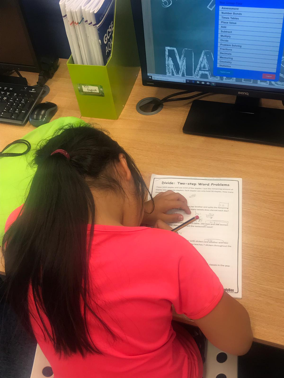 Image of a child studying at a desk.