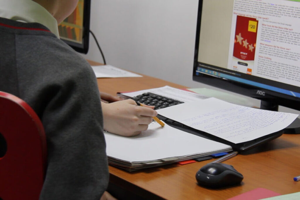 Image of a student at a computer studying