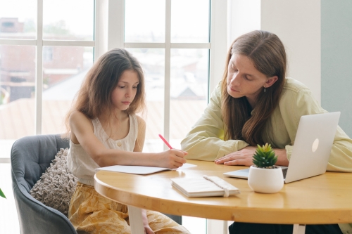 tutor with child sat at table