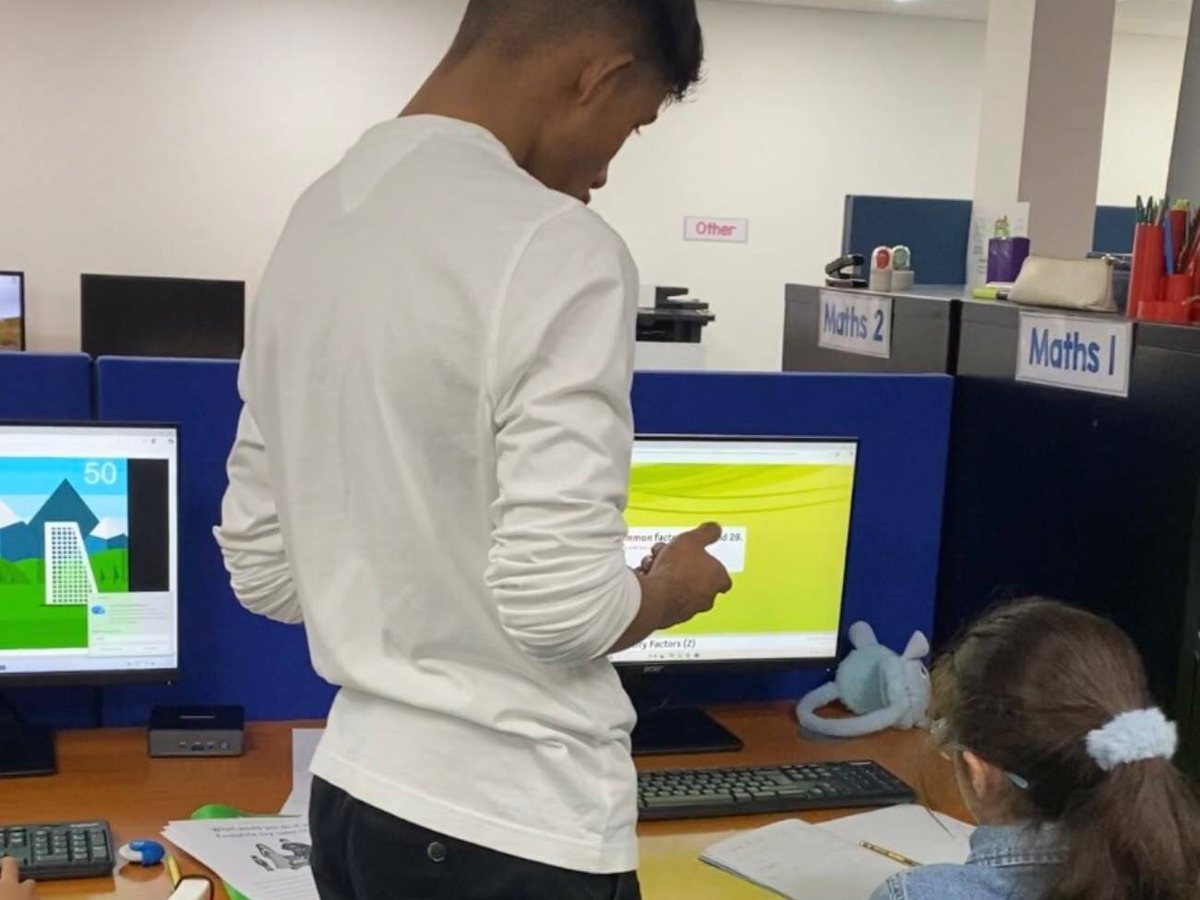 A StudyBox tutor giving focused support to a student at the Sutton tuition centre