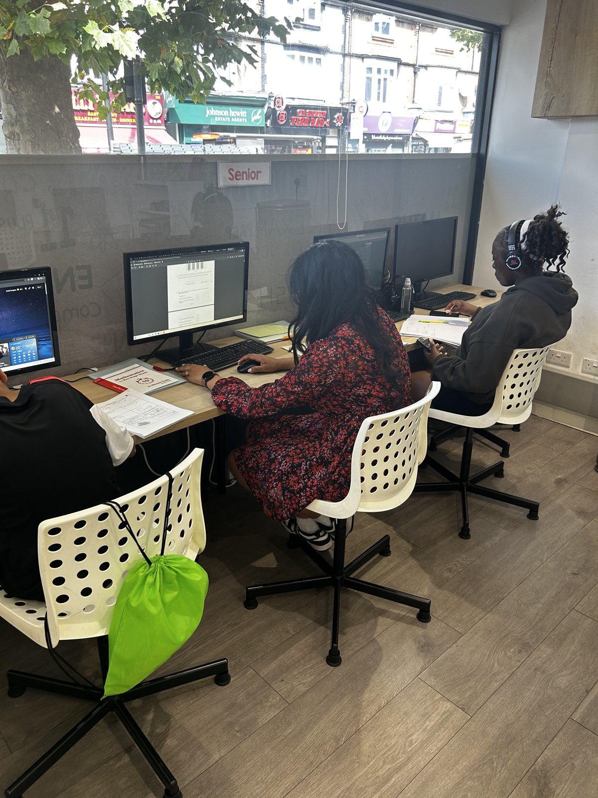 A StudyBox tutor giving focused support to students at the Croydon tuition centre