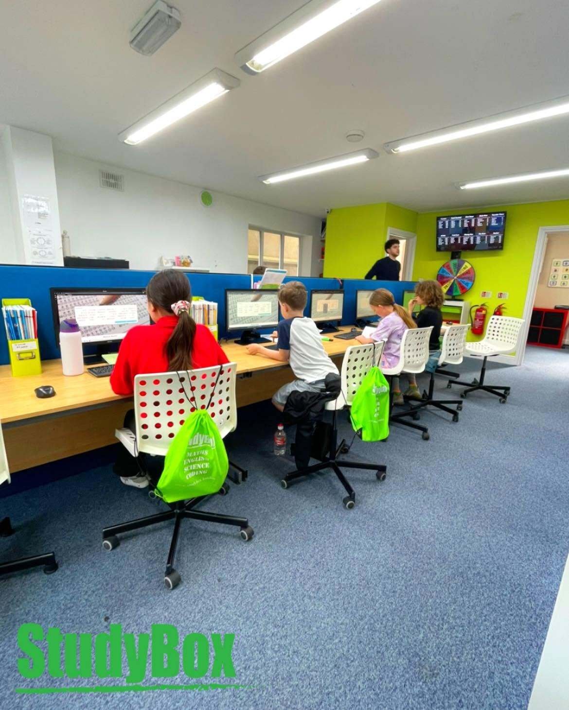 A wide view of students working at desks in the StudyBox Wallington centre
